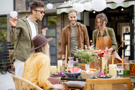 Friends preparing for the festive dinner, serving the table with delicious food at beautiful...