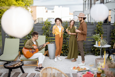 Friends hang out together on a beautiful cottage backyard, playing on a guitar, playing with a dog...