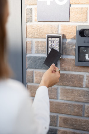 Attaching card to the electronic reader to access the office or apartment, close-up. Card entry,...