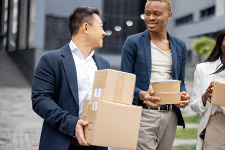 Multiracial business team with parcels walking on city street. Idea of shipping and logistics....