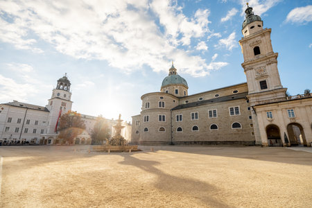 Morning view on Residence Square with famous cathedral on background in Salzburg city. Traveling Austria, visiting famous landmarks conceptの写真素材