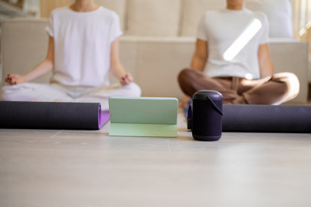 Asian man and european gir practising yoga at home. Concept of relationship and spending time...