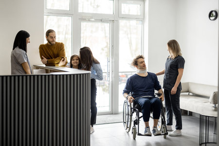 Young people in the lobby of the clinic. Young family with girl talking at the reception desk and...