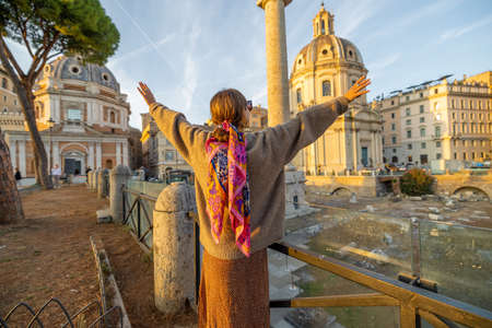 Woman enjoying beautiful sunset view on Roman forum. Concept of traveling italy and visiting famous italian landmarksの写真素材