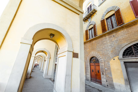 Morning view on beautiful arcade near famous Ponte Vecchio on Arno river in Florence, Italy. Concept...