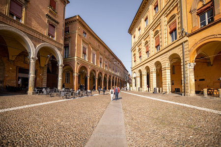 Morning view on Seven churches square in old town of Bologna city. Ancient buildings with galleries...