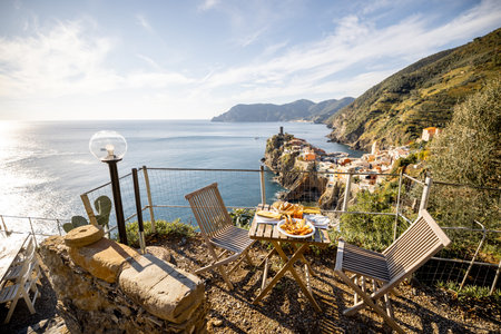 Served lunch table with seafood on coast at Vernazza village in Italy. Concept of mediterranean...