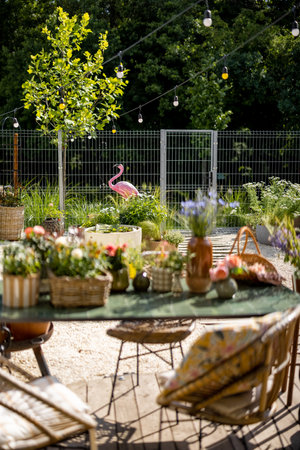 Beautifully landscaped backyard of a country house with a dining table in the foregroundの写真素材