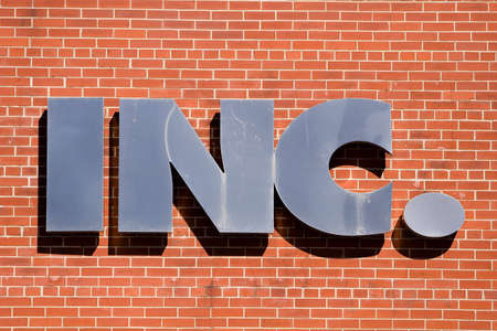 INC. sign on a brick wallの写真素材