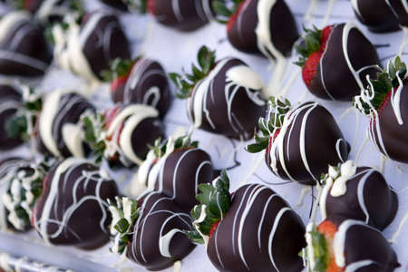 Chocolate covered strawberries with white chocolate drizzled on themの写真素材