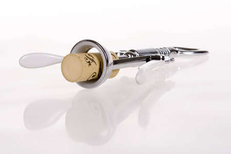 Corkscrew with cork on white backgroundの写真素材