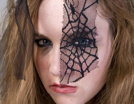 Brunette Model in Goth clothing over white backgroundの写真素材
