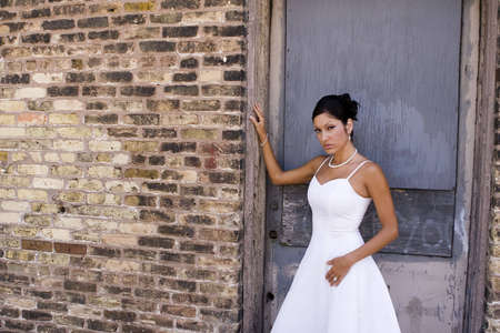 Bridal portrait outdoor with brunette in wedding dressの写真素材