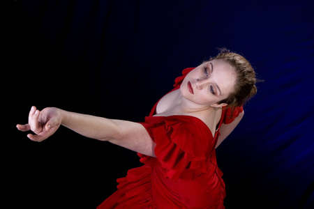 Brunette Model in Red Spanish Dress over blue/black backgroundの写真素材
