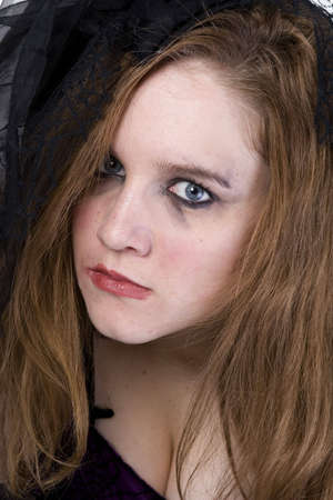 Brunette Model in Goth clothing over white backgroundの写真素材