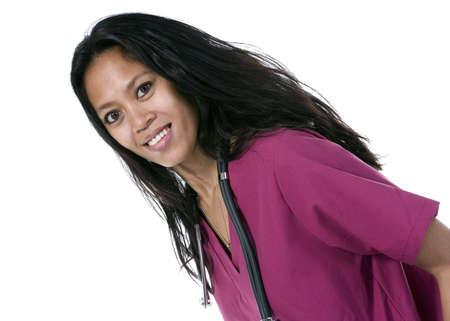 Brunette in medical scrubs over white backgroundの写真素材
