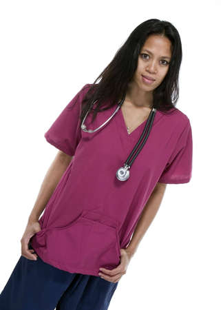 Brunette in medical scrubs over white backgroundの写真素材