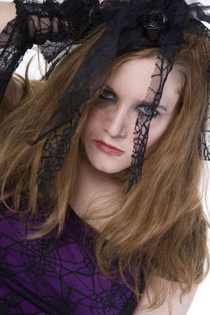 Brunette Model in Goth clothing over white backgroundの写真素材