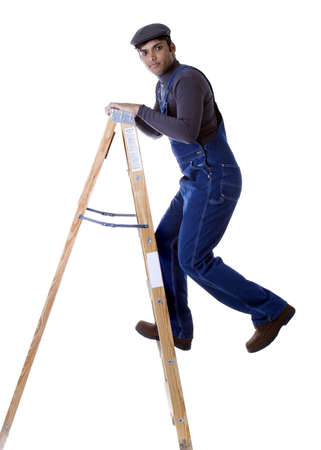 Adult Male Indian Model in overalls with ladderの写真素材