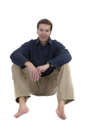 Adult male model in sweater sitting over white backgroundの写真素材