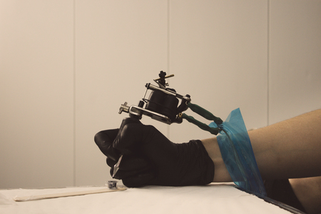 Close up tattoo machine refilling ink.の写真素材