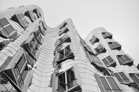 Mirrored metal facade of the Gehry buildings at the Media Harbour in Dusseldorf, Germanyのeditorial素材