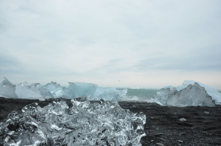 Black sand and crystal clear ice chunks at Diamond Beach in Fellsfjara, Jokulsarlon on Icelandの写真素材