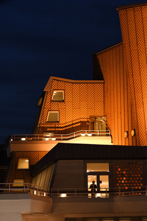 Vertical shot of the golden building of the Berlin Philharmonic Hall at night in Berlin, Germanyのeditorial素材