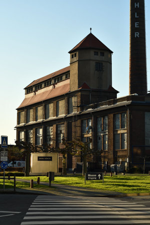 Vertical shot of a historical company building with a tower and chimney on the Areal Boehler siteのeditorial素材