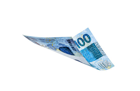 banknote of one hundred reais from brazil falling on isolated white background