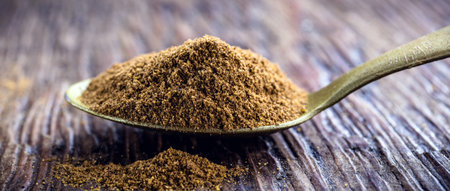 spoon of powdered cinnamon, spice obtained from the inner bark of several species of trees of the...