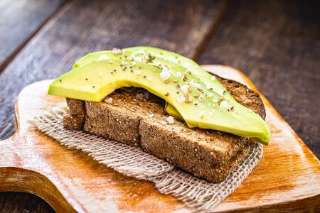 Gluten-free vegan bread toast, with avocado, oats and ground chestnuts. Vegan meal, healthy food.の写真素材