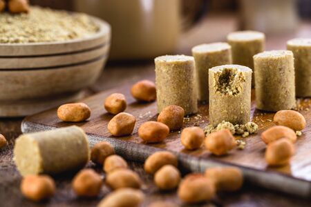 peanut jam on rustic table with pieces of peanut around. Brazilian paÃ§oca.の写真素材