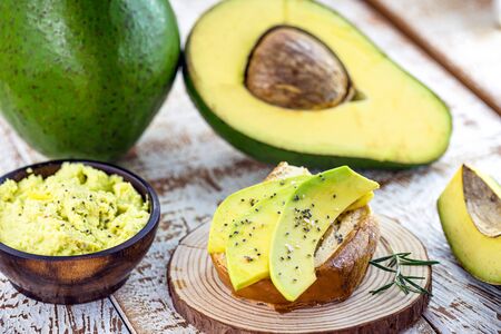 Tasty avocado sliced ??on crunchy toast, with grains and spices. Healthy breakfast, diet concept.の写真素材