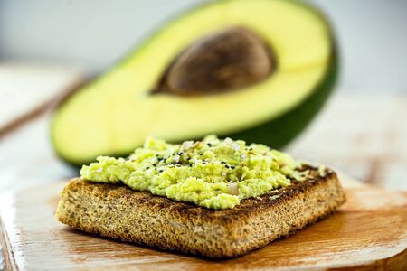 Avocado on crunchy toast, with seasonings and spices. Vegan bread made from organic yeast.の写真素材