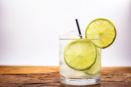 Caipirinha, a typical Brazilian cocktail made with lemon, cachaÃ§a and sugar. Brazilian traditional drink isolated with white background and space for text.の写真素材