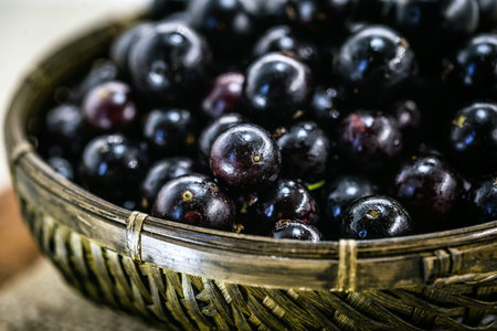 Fruit called Jaboticaba or jabuticaba in a basket on a white background, preserves organic and...
