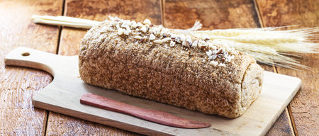Vegan product made at home, totally organic. Bread on rustic wooden background, with Brazilian...