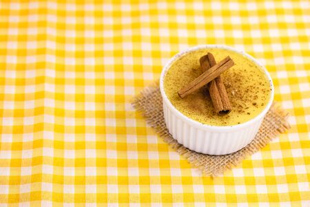 Dessert of curau. Brazilian sweet corn, corn mousse with cinnamon on a wooden background. Typical Brazilian dessert, sweet of June party. Dessert, canjica or JimbelÃª.の写真素材