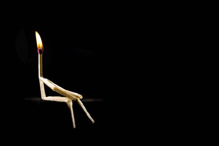conceptual image of creativity, man made of match with flame on head. having an idea and standing out on the team.の写真素材