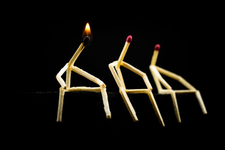 conceptual image of creativity, man made of match with flame on head. having an idea and standing...