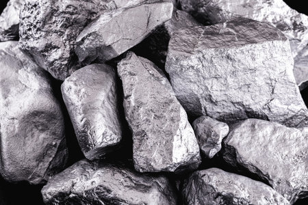 Raw manganese. Manganese stone isolated on black background. Mineral extraction of heavy metals from...
