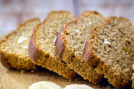sliced â€‹â€‹bread on rustic table, vegan bread with banana, oat and honey flavor.