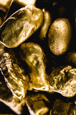 gold texture, many gold nugget, stone of value. Crude gold drawn on black background. Concept of...
