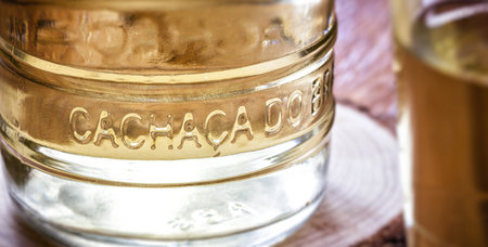 detail of cachaÃ§a bottle, international cachaÃ§a day in brazil, september 13, with rustic wood...