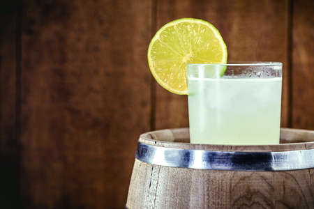 Brazilian Caipirinha, typical Brazilian cocktail made with lemon, cachaÃ§a and sugar. Traditional drink from Brazil, isolated with space for textの写真素材