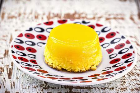 Egg yolk candy, called Quindim in Brazil and Brisas do Liz in Portugal, with grated coconut, almonds, sugar and milk in its ingredients.の写真素材