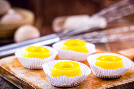 several sweets called "Quindim", Brazilian sweet made from egg yolk, sugar and grated coconut. Yellow sweet typical of Brazilian cuisine.の写真素材