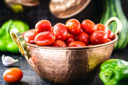 Brazilian tomato in copper saucepan, fresh fruit, salad ingredientの写真素材