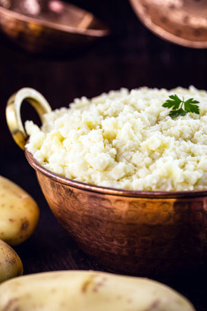 mashed potatoes in copper metallic pan, Brazilian food served as a garnish or side dish.